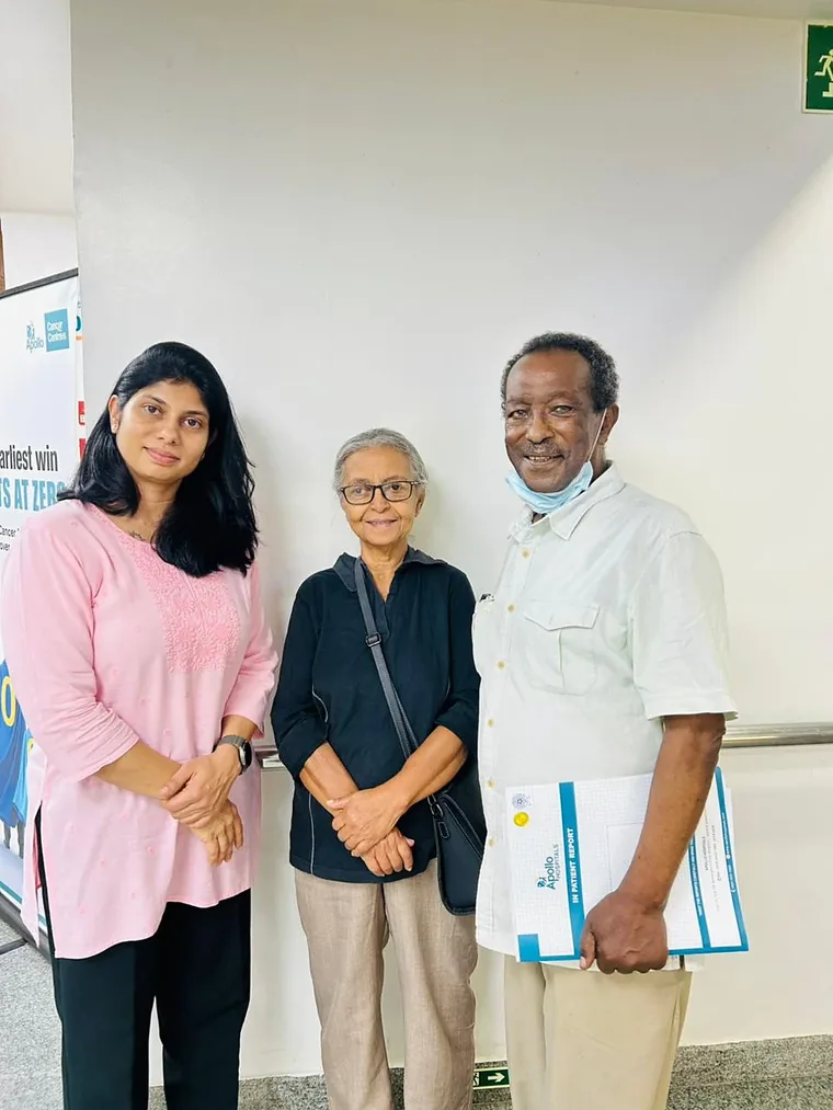 Dr. Neema Bhat standing with two smiling patients at the hospital